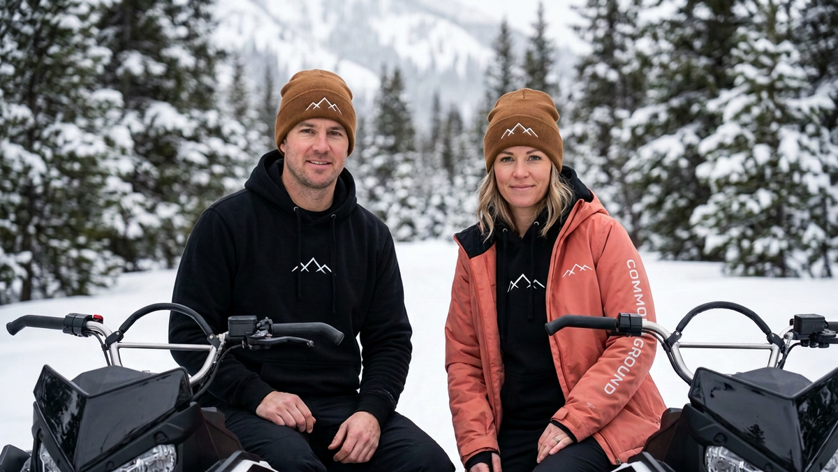 Revised snowmobile apparel image with smaller Common Ground lettering on the woman’s jacket sleeve